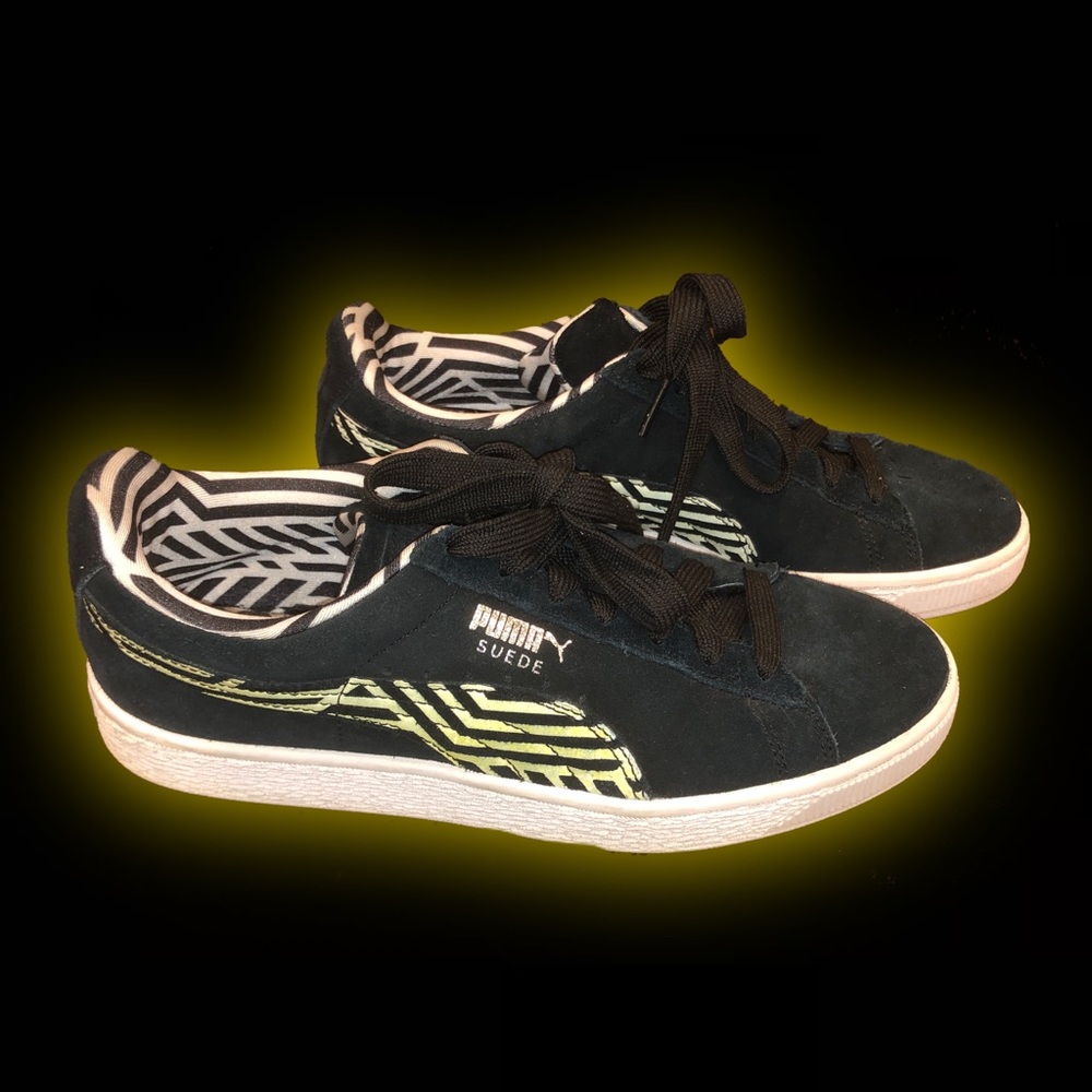 black suede pumas with green zig zag accent